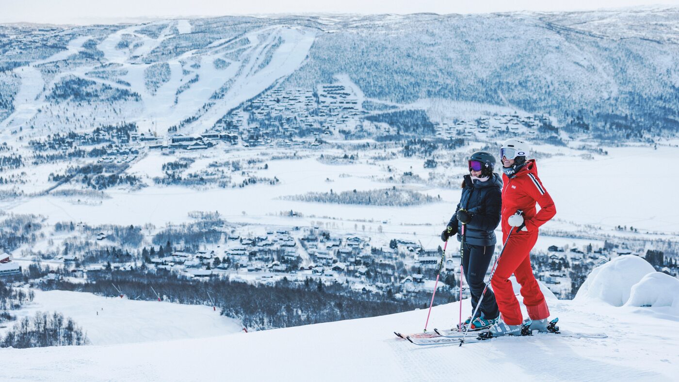Two skiers overlooking Geilo's snow-covered ski area
